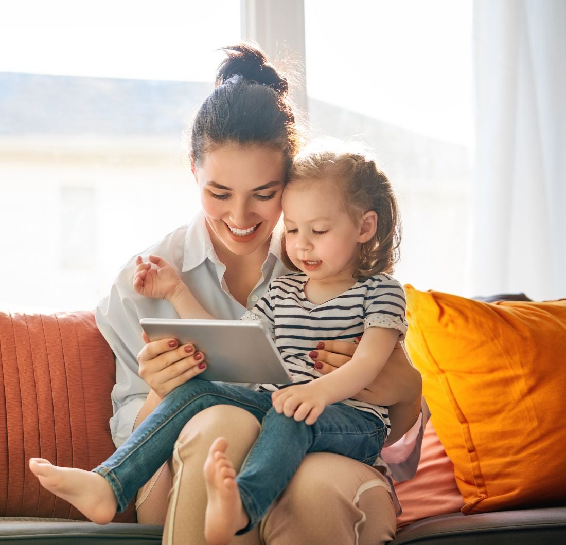 Mom and toddler reading tablet